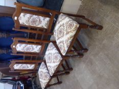 Six 'Old Charm' Dining Chairs, two carvers and four straight chairs with tapestry upholstery.