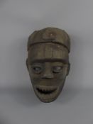 A West African Gabonese Tribal Fang Mask, carved of heavy wood, approx 42 cms, the mask carved