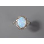 A 9ct White Gold Diamond and Opal Ring. The opal measuring approx 10 x 8 mm and surrounded by approx