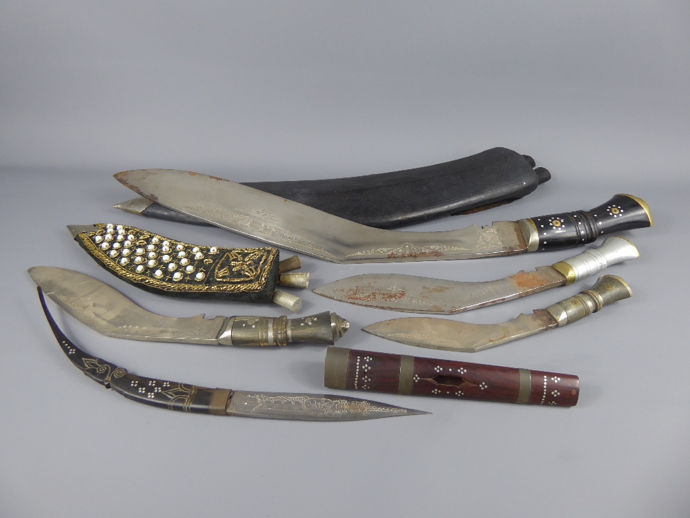 A Large Nepalese Kukri, the kukri with leather scabbard and brass mounted decorative handle,