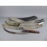 A Large Nepalese Kukri, the kukri with leather scabbard and brass mounted decorative handle,