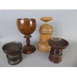 Four Treen items, including a pair of pounce pots, spice grinder and oak goblet.
