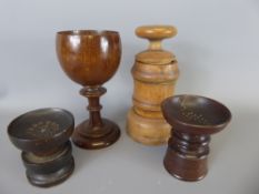 Four Treen items, including a pair of pounce pots, spice grinder and oak goblet.