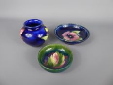 Three Moorcroft items, including a small blue 'Hibiscus' vase (approx 7.5 cms high), a small