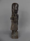A West African Carved Figure of an Elder, approx 28 cms (af) together with a carved wood flat