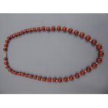 A Red Stone and Gold Metal Beaded Necklace, the necklace on 14k stamped clasp, approx 49 cms in