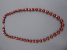 A Red Stone and Gold Metal Beaded Necklace, the necklace on 14k stamped clasp, approx 49 cms in