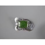 An Arts and Crafts Silver and Translucent Spinach Jade Brooch, the jade measuring approx 22 x 17 mm,