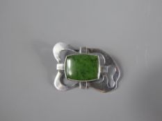 An Arts and Crafts Silver and Translucent Spinach Jade Brooch, the jade measuring approx 22 x 17 mm,