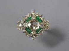 An 18ct Yellow Gold Diamond and Emerald Star Form Ring. The ring set with a central diamond of 1.