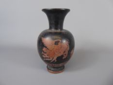 An Ancient Greek Terracotta Oil Jug, depicting a winged figure, approx 15 cms.