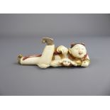 A Japanese Stained Ivory Okimono, depicting a woman and Pekinese (wf) approx 11 cms