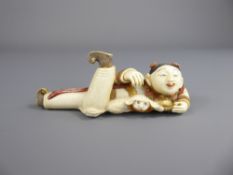 A Japanese Stained Ivory Okimono, depicting a woman and Pekinese (wf) approx 11 cms