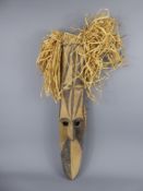 An Oceanic Mask, elongated facial expression, believed to be Igiri wood, the frame of plaited palm