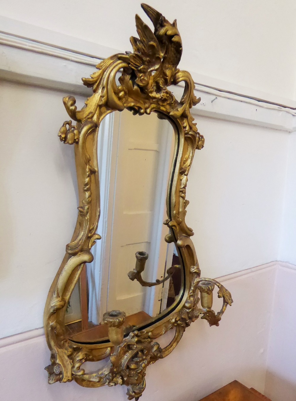 An Early 19th Century Rococo Gilt-Wood Mirror, the frame having carved foliate decoration with two