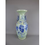 An Antique Celadon Ground and Blue Vase, depicting figures beneath a prunus, approx 63 cms.