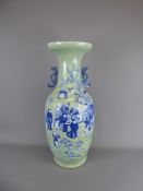 An Antique Celadon Ground and Blue Vase, depicting figures beneath a prunus, approx 63 cms.