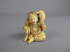 Antique Japanese Netsuke, carved figure of a seated man with a salamander on his shoulder, approx