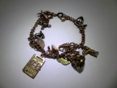 A Lady's 9 ct Gold Charm Bracelet, bracelet with twelve charms, five hallmarked 9 ct and one 15