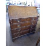 An Antique Oak Drop Front Bureau, the bureau with fitted pigeon hole interior and three drawers on