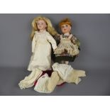 Two Bisque-Headed Dolls, with bisque hands and legs, approx 40 cms with a small quantity of