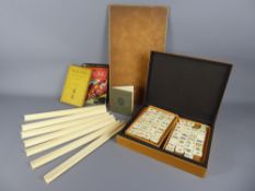 A Mahjong Set, contained within a bamboo box, together with a number of boards and instruction