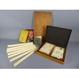 A Mahjong Set, contained within a bamboo box, together with a number of boards and instruction