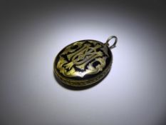 An Antique 14/15 ct Yellow Gold and Black Enamel Mourning Locket, the locket having floral engraving