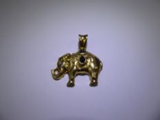 An Indian Style 18 ct Yellow Gold, Diamond, Ruby and Emerald Elephant Pendant, one 1pt diamond, four