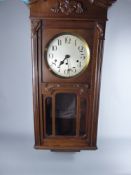 A German Kienzle Large Oak Wall Clock, approx 94 x 39 x 18 cms.