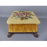 A Regency Foot Stool, wood framed with lion claw feet, tapestry top depicting roses.