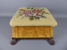 A Regency Foot Stool, wood framed with lion claw feet, tapestry top depicting roses.