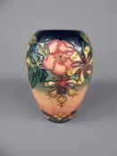A William Moorcroft Vase, 'Dog Rose and Honeysuckle', approx 18.5 cms.