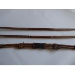 Two Antique Yew Wood Long Bows, approx 182 cms, both with hide grips together with a tribal