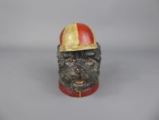 A Victorian Metal Inkwell in the form of a dog wearing a red and cream jockey cap, marks to back G E