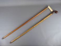 Two Antique Walking Sticks, including a Victorian Ivory Handled Cane with silver collar dated 1897