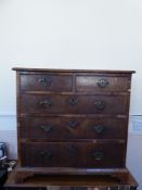 An Antique Chest of Drawers, two short drawers and three graduated drawers beneath, brass swan