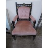 An Edwardian Ebonised Arm Chair, decorated with a bird and flower sprigs, covered in original pink