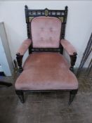 An Edwardian Ebonised Arm Chair, decorated with a bird and flower sprigs, covered in original pink