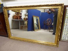 An Ornate Gilt Wood Style Wall Mirror, approx 90 x 137 cms.