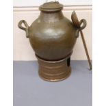 An Egyptian Copper Street Vendor's Food Warmer, together with a copper serving vessel and ladle.