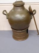 An Egyptian Copper Street Vendor's Food Warmer, together with a copper serving vessel and ladle.