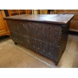 An Antique Heavy Oak Ecclesiastical Coffer, the coffer having decorative carving to front, carved