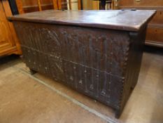 An Antique Heavy Oak Ecclesiastical Coffer, the coffer having decorative carving to front, carved