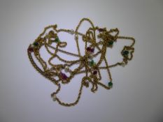 An Antique Yellow Gold, Seed Pearl, Emerald and Ruby Muff Chain, approx 170 cms, approx 22.5 gms.