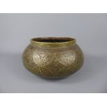 Persian Metalwork. An 18/19th Century Pierced Brass Bowl. The bowl depicting flowers and inlaid with