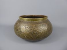 Persian Metalwork. An 18/19th Century Pierced Brass Bowl. The bowl depicting flowers and inlaid with