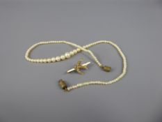 An Antique 18 Ct Gold (tested) Seed Pearl Swallow Brooch, approx 2.2 gms together with a graduated