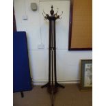 An Edwardian Hat and Coat Stand. The stand has a revolving top with finial, splayed feet, decorative