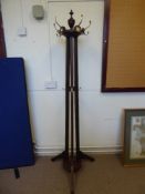 An Edwardian Hat and Coat Stand. The stand has a revolving top with finial, splayed feet, decorative